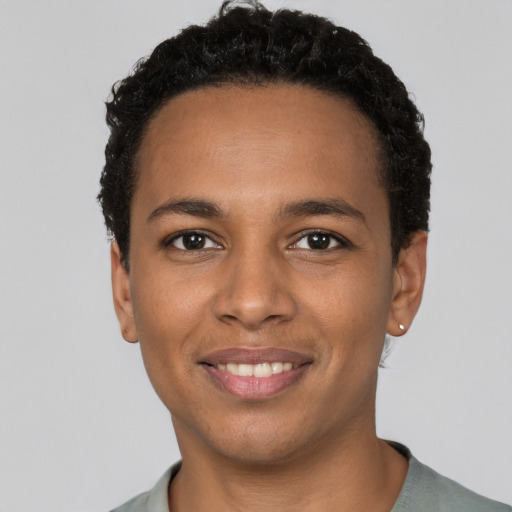 Joyful black young-adult male with short  black hair and brown eyes