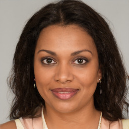 Joyful black young-adult female with medium  brown hair and brown eyes