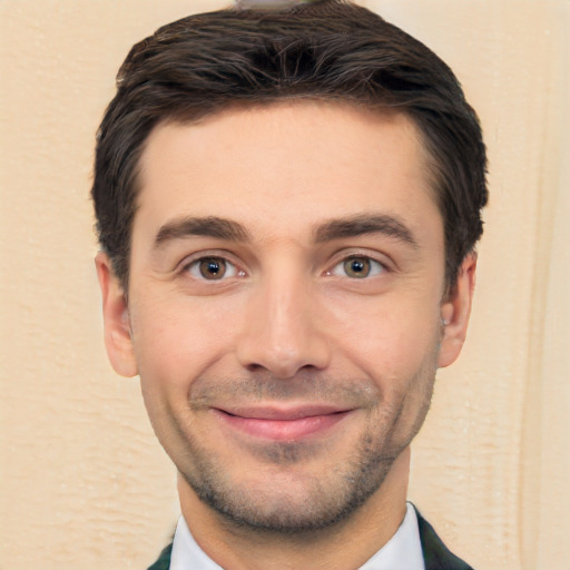 Joyful white young-adult male with short  black hair and brown eyes