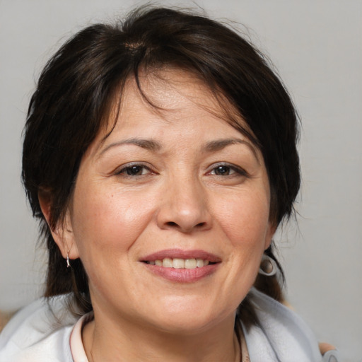 Joyful white adult female with medium  brown hair and brown eyes