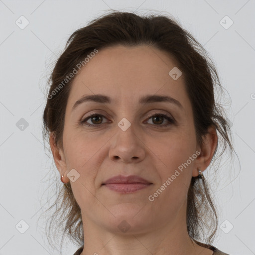 Joyful white adult female with medium  brown hair and grey eyes