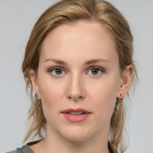 Joyful white young-adult female with medium  brown hair and blue eyes