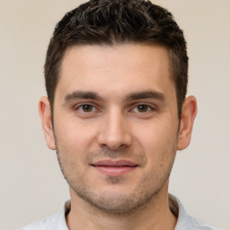 Joyful white young-adult male with short  brown hair and brown eyes