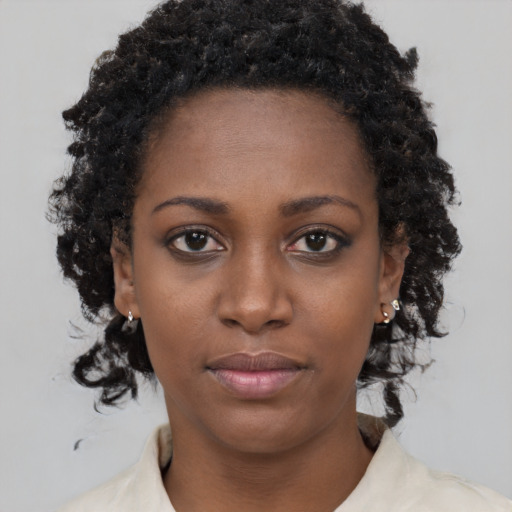 Neutral black young-adult female with medium  brown hair and brown eyes