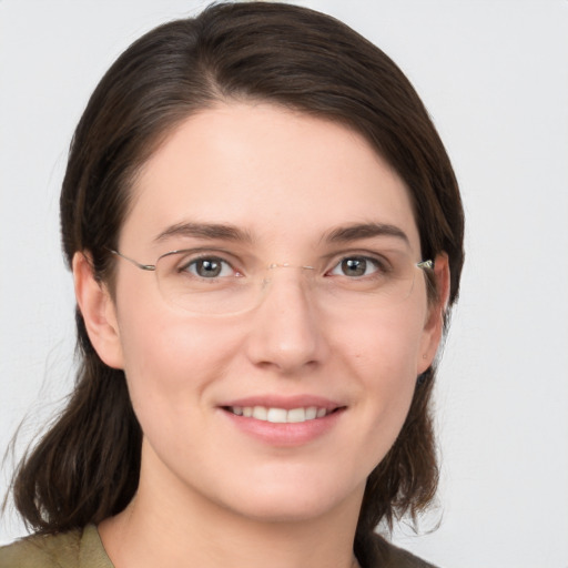 Joyful white young-adult female with medium  brown hair and grey eyes