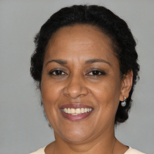 Joyful black adult female with short  brown hair and brown eyes