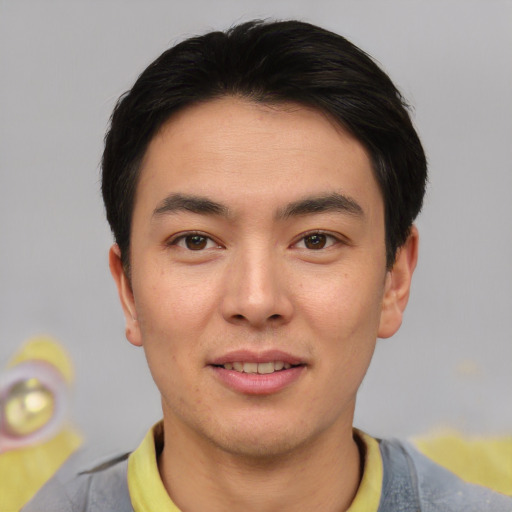 Joyful asian young-adult male with short  black hair and brown eyes
