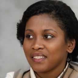 Joyful black young-adult female with medium  black hair and brown eyes