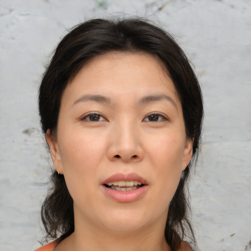 Joyful asian young-adult female with medium  brown hair and brown eyes