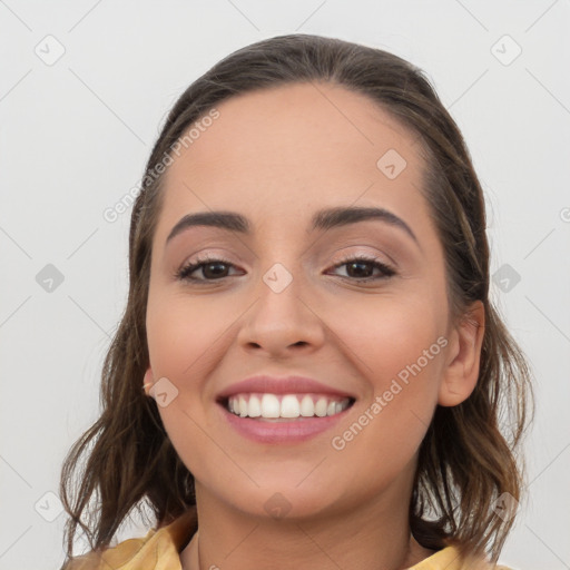 Joyful white young-adult female with long  brown hair and brown eyes