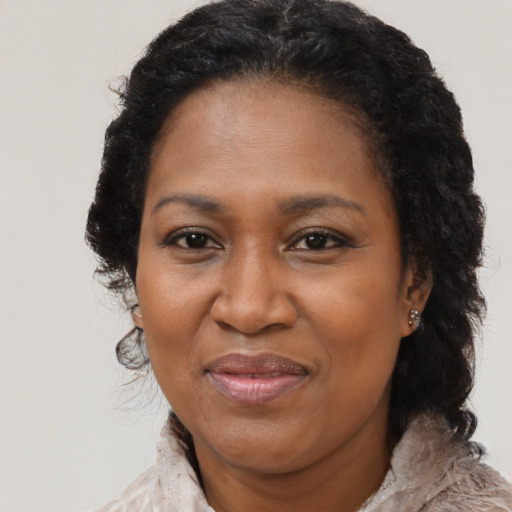 Joyful black adult female with medium  black hair and brown eyes