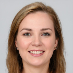 Joyful white young-adult female with long  brown hair and grey eyes