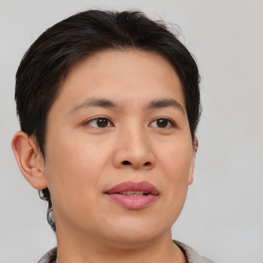 Joyful asian young-adult female with short  brown hair and brown eyes