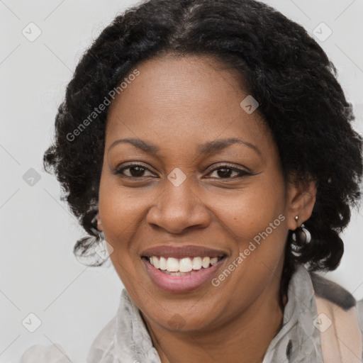 Joyful black adult female with medium  brown hair and brown eyes