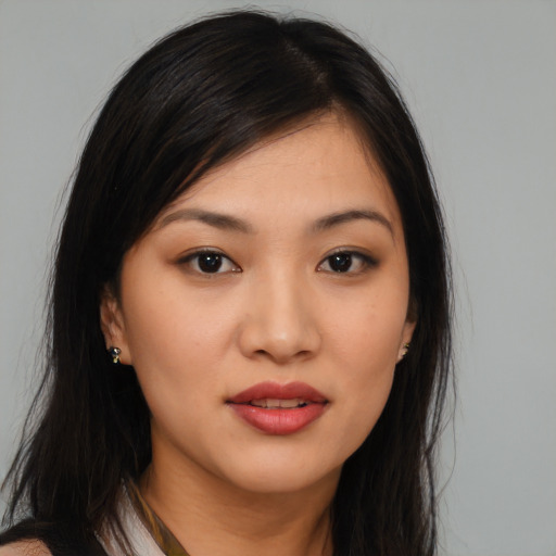 Joyful asian young-adult female with long  brown hair and brown eyes