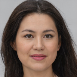 Joyful white young-adult female with long  brown hair and brown eyes