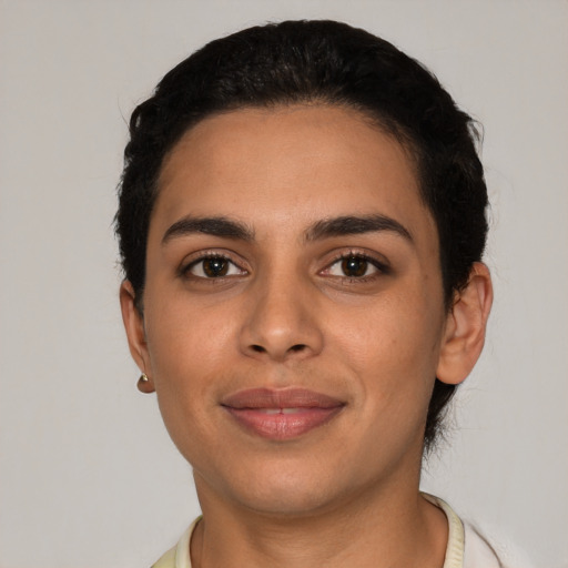 Joyful latino young-adult female with short  black hair and brown eyes