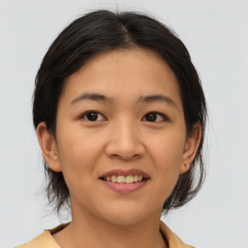 Joyful asian young-adult female with medium  brown hair and brown eyes