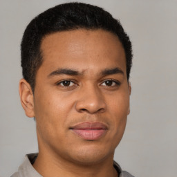 Joyful latino young-adult male with short  brown hair and brown eyes