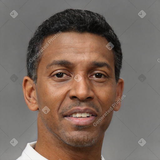 Joyful black adult male with short  black hair and brown eyes