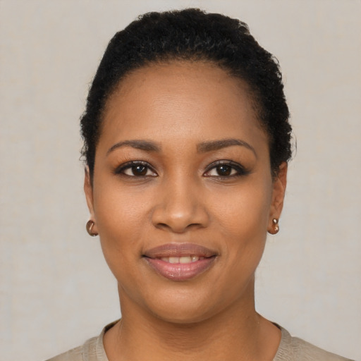 Joyful black young-adult female with short  black hair and brown eyes