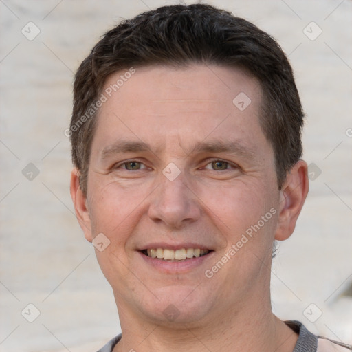 Joyful white adult male with short  brown hair and grey eyes