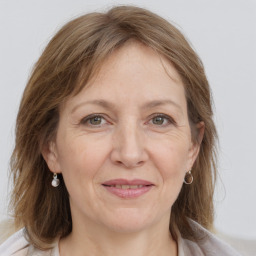 Joyful white adult female with medium  brown hair and grey eyes