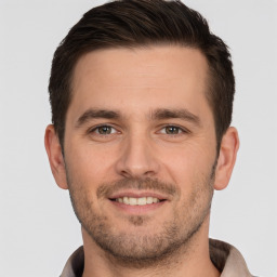 Joyful white young-adult male with short  brown hair and brown eyes