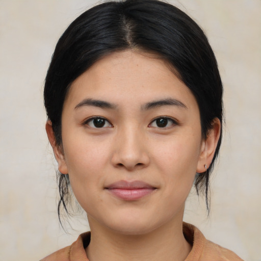 Joyful asian young-adult female with medium  black hair and brown eyes