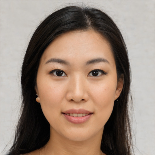 Joyful asian young-adult female with long  black hair and brown eyes