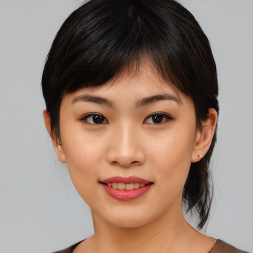 Joyful asian young-adult female with medium  brown hair and brown eyes