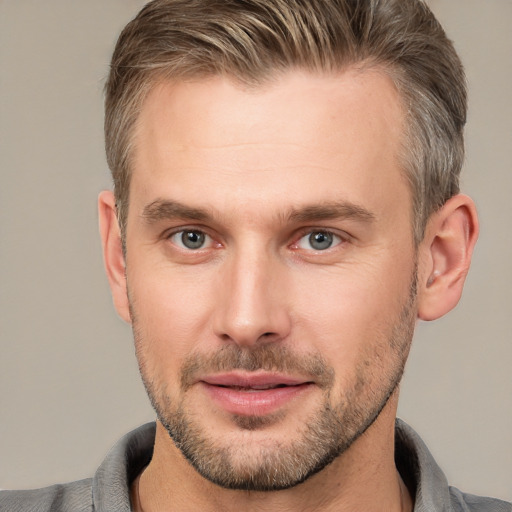 Joyful white adult male with short  brown hair and brown eyes