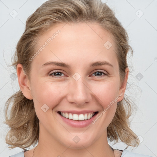 Joyful white young-adult female with medium  brown hair and blue eyes