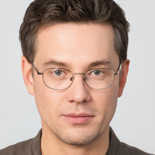 Joyful white adult male with short  brown hair and grey eyes