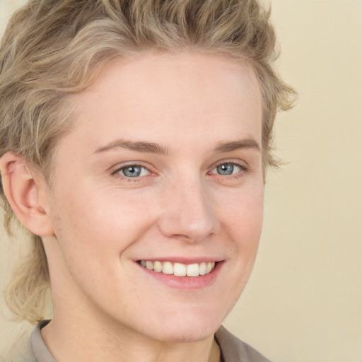 Joyful white young-adult female with short  brown hair and blue eyes