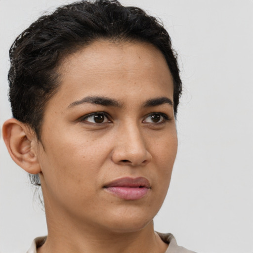 Joyful latino young-adult female with short  brown hair and brown eyes