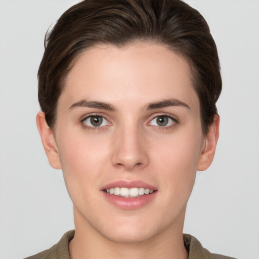 Joyful white young-adult female with short  brown hair and brown eyes