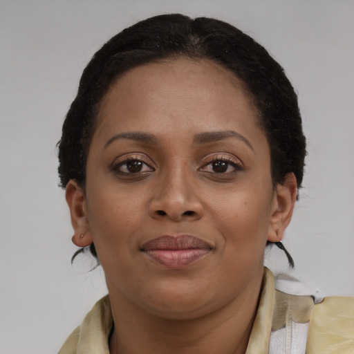 Joyful black young-adult female with medium  brown hair and brown eyes