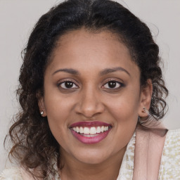 Joyful latino young-adult female with medium  brown hair and brown eyes