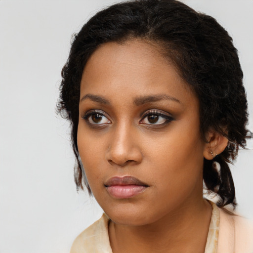 Neutral black young-adult female with long  brown hair and brown eyes