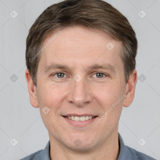 Joyful white adult male with short  brown hair and grey eyes