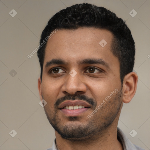 Joyful black young-adult male with short  black hair and brown eyes