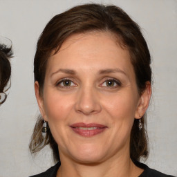 Joyful white adult female with medium  brown hair and brown eyes