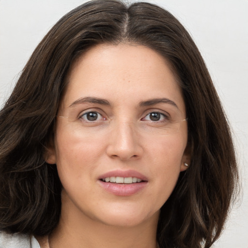 Joyful white young-adult female with long  brown hair and grey eyes