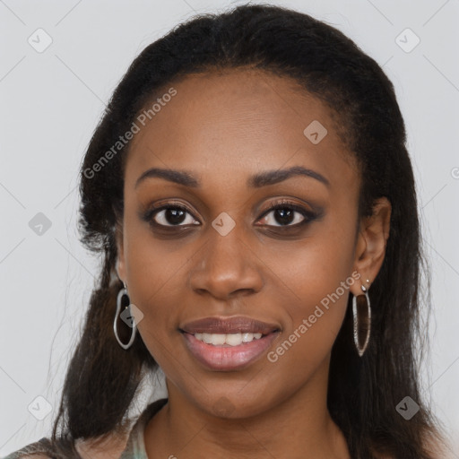 Joyful black young-adult female with long  brown hair and brown eyes