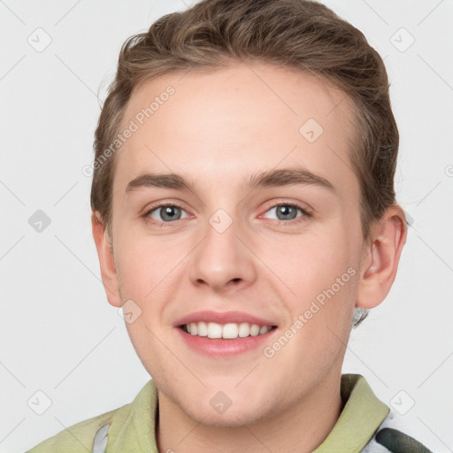 Joyful white young-adult male with short  brown hair and grey eyes