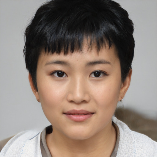 Joyful asian child female with short  black hair and brown eyes