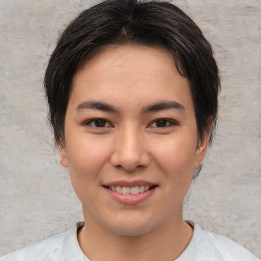 Joyful asian young-adult female with short  brown hair and brown eyes