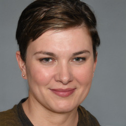 Joyful white young-adult female with medium  brown hair and grey eyes