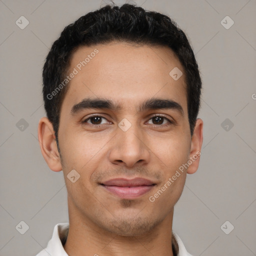 Joyful latino young-adult male with short  black hair and brown eyes